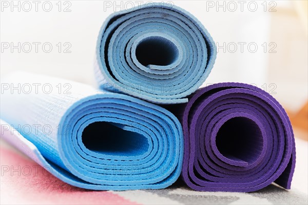 Pile of yoga mats on floor