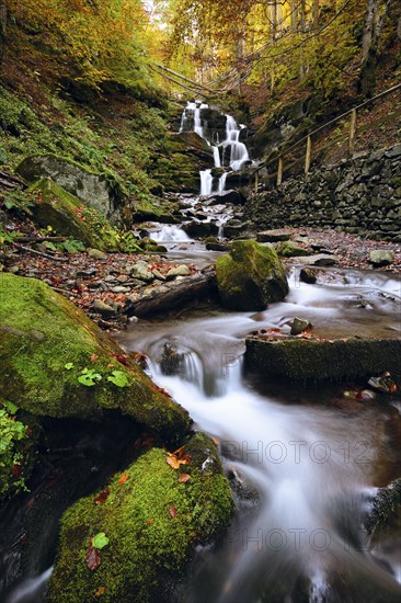 Ukraine, Zakarpattia region, Carpathians, Verkhniy Shypot waterfall, Blurred waterfall in autumn woods