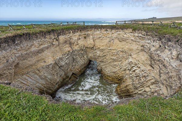 USA, California, San Luis Obispo, Sinkhole at edge of coastal bluff