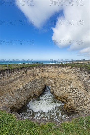 USA, California, San Luis Obispo, Sinkhole at edge of coastal bluff