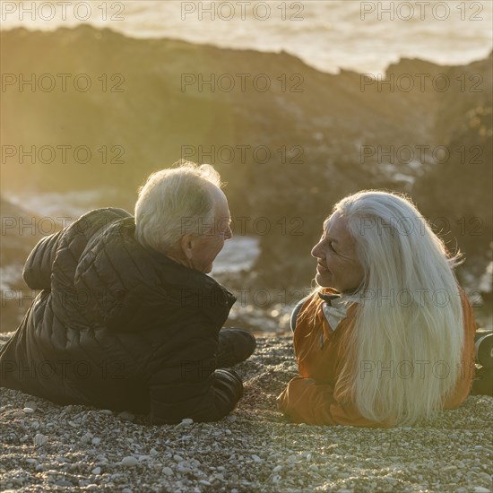 Senior couple enjoying sunset on beach