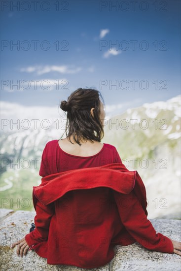 Switzerland, Appenzell, Woman in red jacket looking at mountain landscape