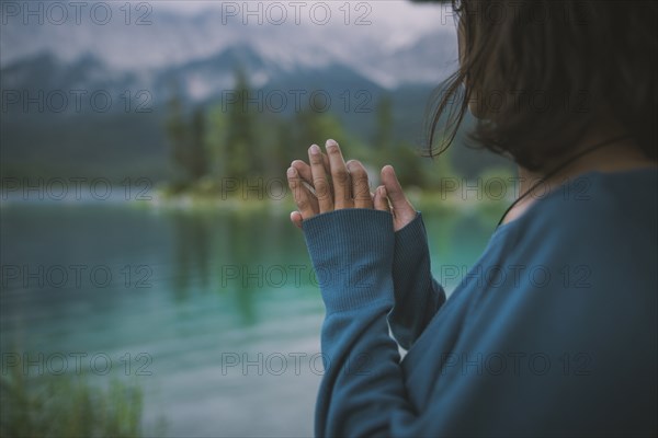 Germany, Bavaria, Eibsee, Young woman standing by Eibsee lake in Bavarian Alps
