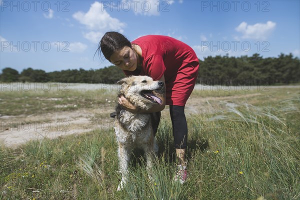 Young woman walking dog from animal shelter