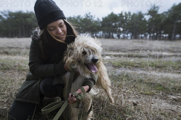 Young woman walking dog from animal shelter