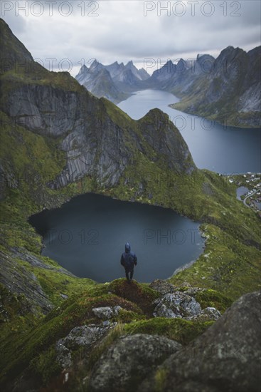 Norway, Lofoten Islands, Reine, Man looking at view from Reinebringen mountain