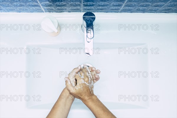 Close-up of teenage boy (16-17) washing hands