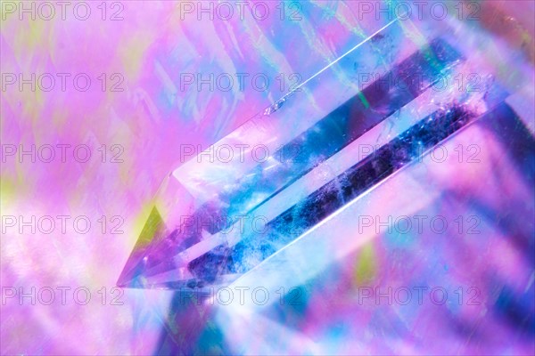 Quartz crystal on purple background