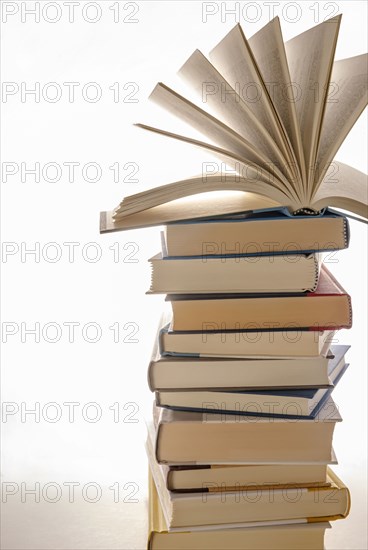 Open book on top of stacked books