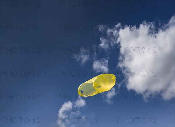 Yellow plastic bag in sky