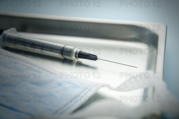 Needle and hygiene mask on tray