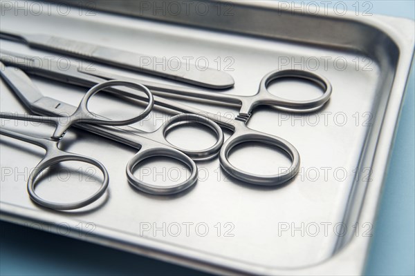 Forceps and scalpel on tray