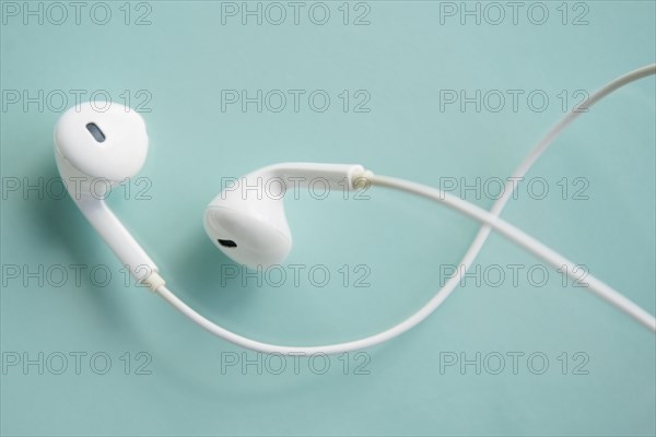 Earphones on blue background