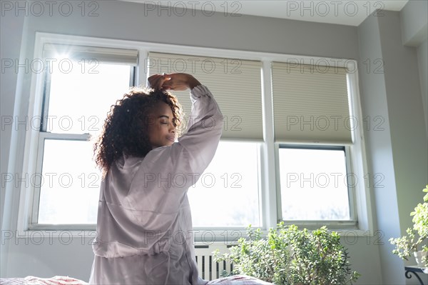 Woman stretching on bed