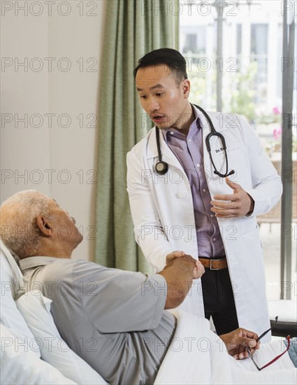 Senior man and doctor shaking hands