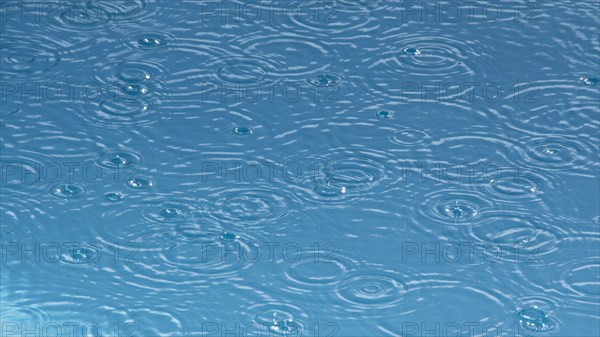 Ripples from rain drops in pond