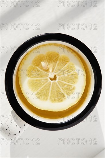 Lemon slice in cup of tea