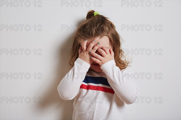 Girl covering her eyes