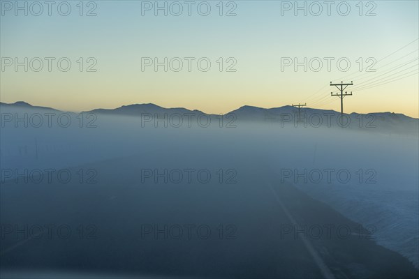 Road in fog at sunrise