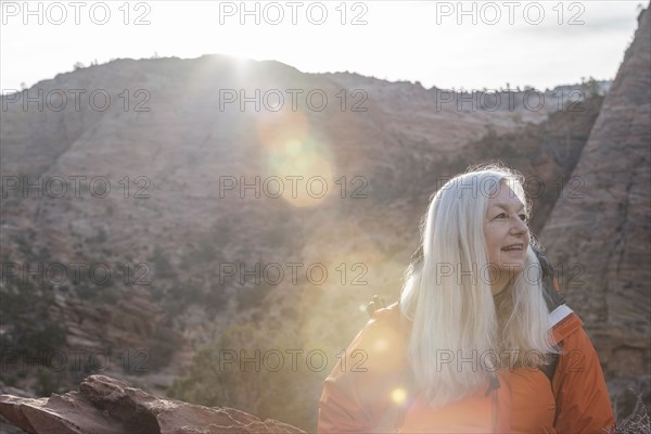 Smiling woman by canyon at Zion National Park in Utah, USA