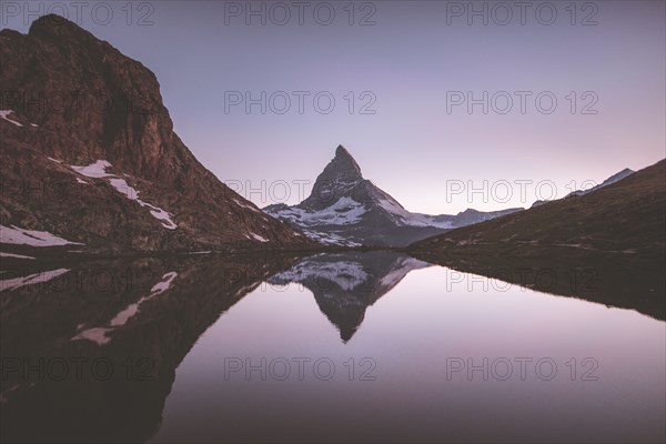 Matterhorn mountain and lake at sunrise in Valais, Switzerland