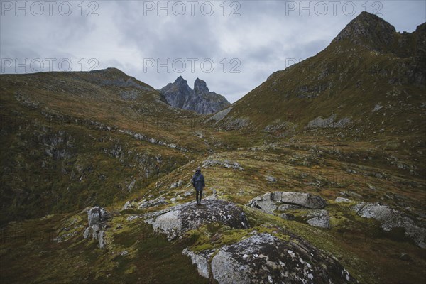 Man standing on mountain in Lofoten Islands, Norway