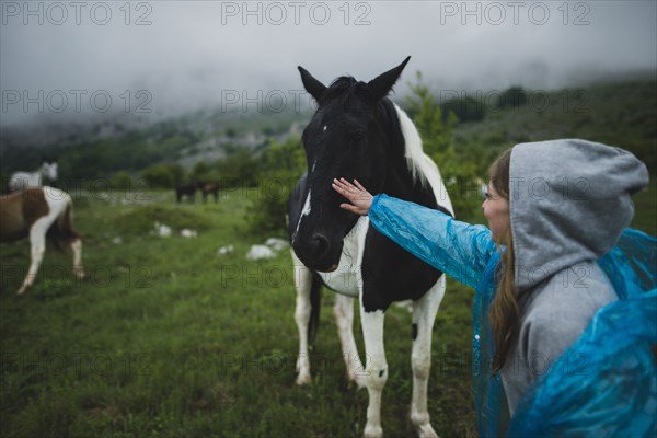 Woman petting Icelandic horse