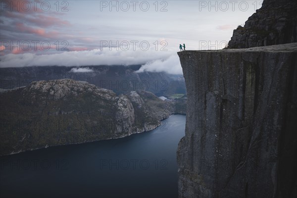 People standing on Preikestolen cliff in Rogaland, Norway