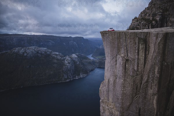 Tent in distance on Preikestolen cliff in Rogaland, Norway