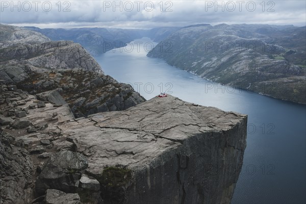 Tent in distance on Preikestolen cliff in Rogaland, Norway