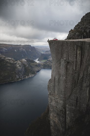 Person and tent on Preikestolen cliff in Rogaland, Norway