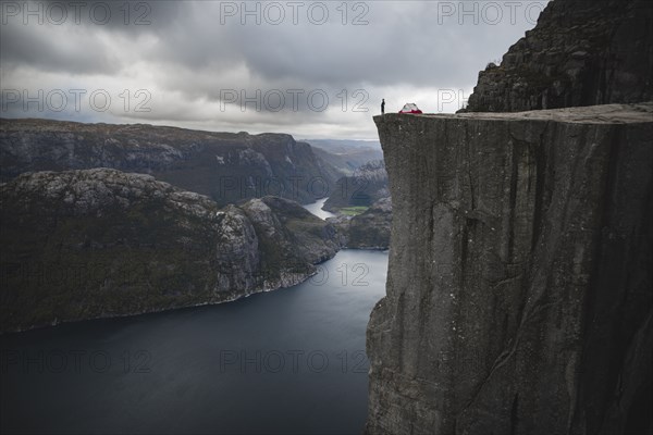 Person and tent on Preikestolen cliff in Rogaland, Norway