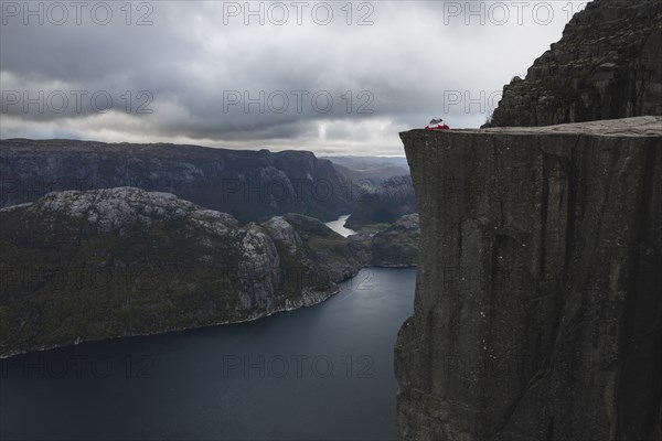 Tent in distance on Preikestolen cliff in Rogaland, Norway