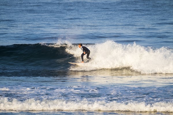 Teenage boy surfing waves