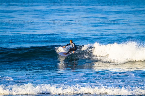 Teenage boy surfing waves