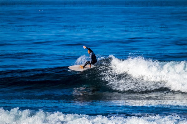 Teenage boy surfing waves