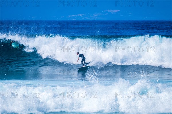 Teenage boy surfing waves