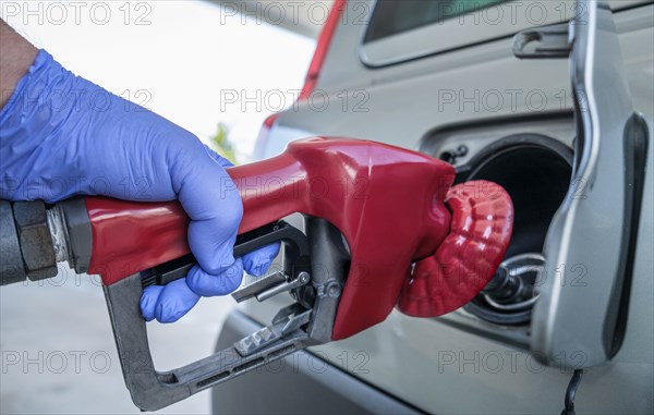 Gloved hand refueling car