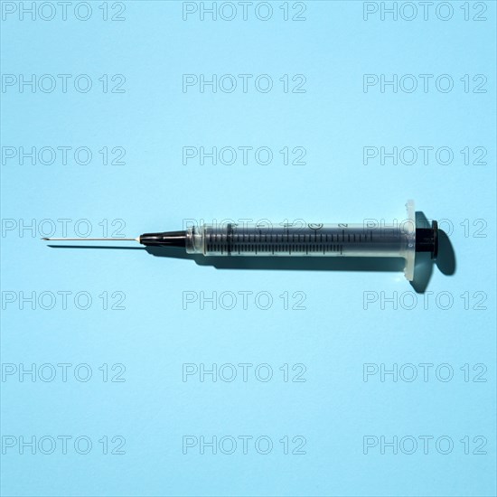 Syringe on blue background