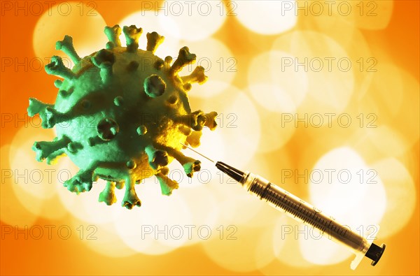 Model of Coronavirus with hypodermic needle