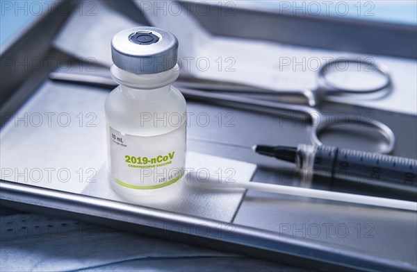 Vial of coronavirus vaccine on medical tray