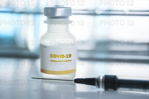 Vial of covid-19 vaccine and hypodermic needle