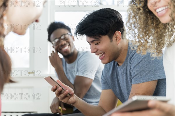 Man using phone while hanging out with friends