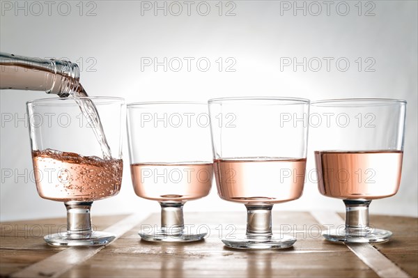 Rose wine being poured into glasses