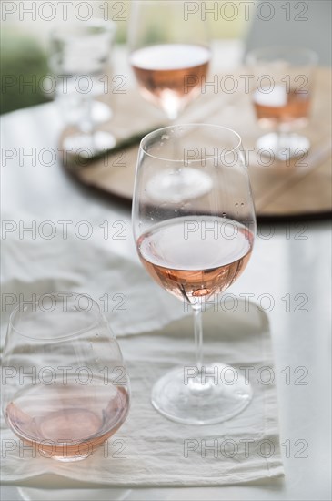 Glasses of rose wine on table