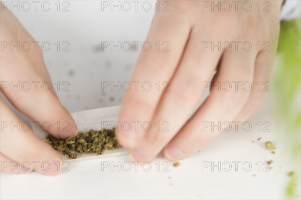 Close up of person rolling a joint