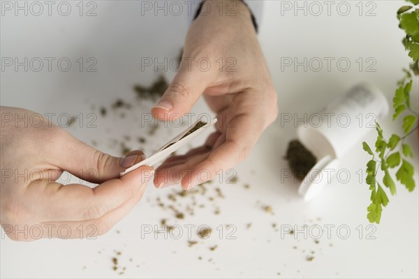 Close up of person rolling a joint