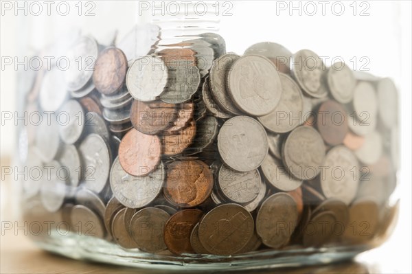 Close up of coins in large jar