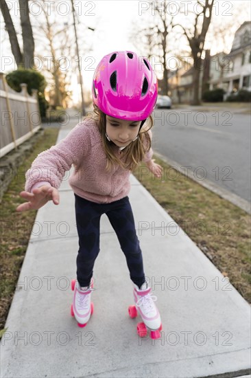 Girl learning to rollerskate