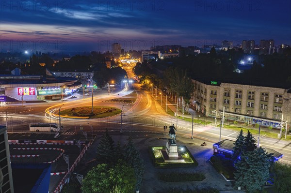 Moldova, Chisinau, Cityscape illuminated at dusk